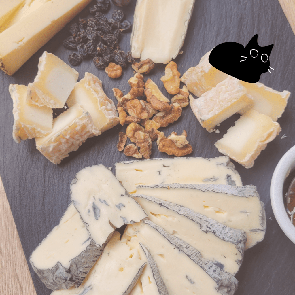 Cheese plate with hard goat cheese, blue cheese, and other soft French cheeses. 